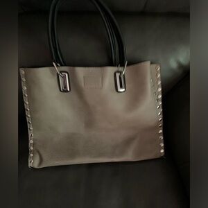 Brown purse lined with silver studs also with a smaller pouch style purse.